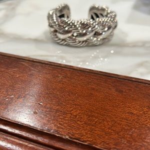 David Yurman sterling hard bangle with a spring on one side .